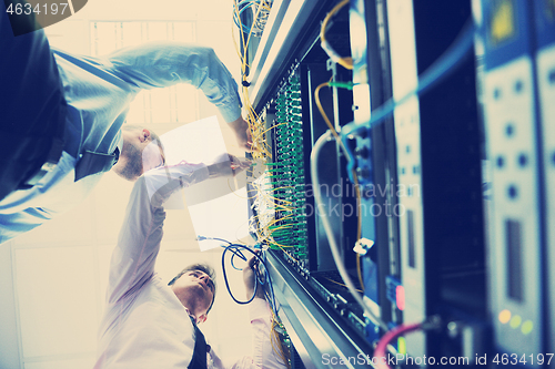 Image of it engineers in network server room