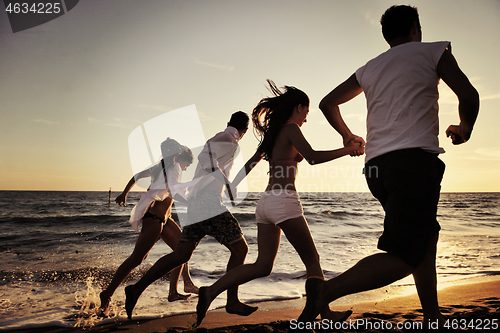 Image of people group running on the beach