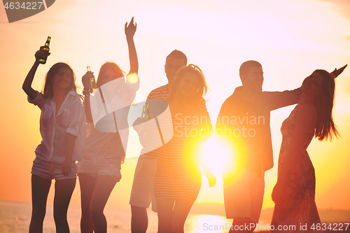 Image of Group of young people enjoy summer  party at the beach