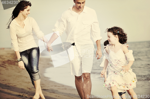 Image of happy young family have fun on beach