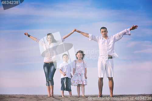 Image of family on beach showing home sign