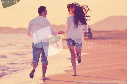 Image of young couple  on beach have fun