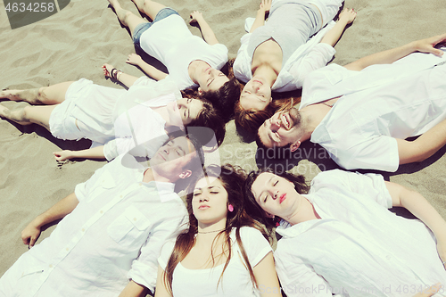 Image of Group of happy young people in have fun at beach