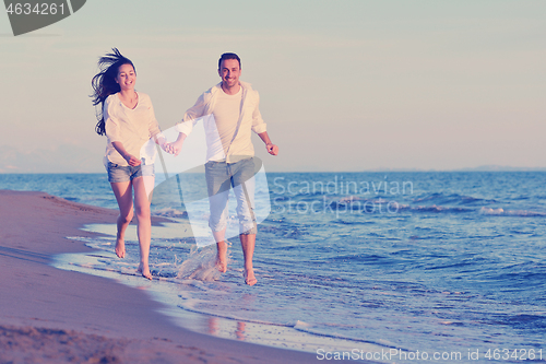 Image of young couple  on beach have fun