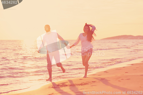 Image of young couple  on beach have fun