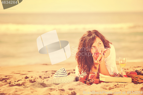 Image of happy young woman on beach