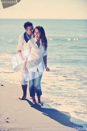 Image of happy young couple have fun at beautiful beach