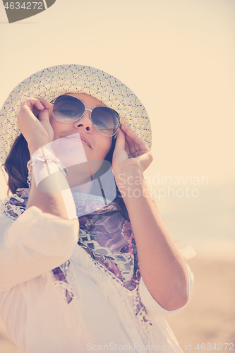 Image of happy young woman on beach