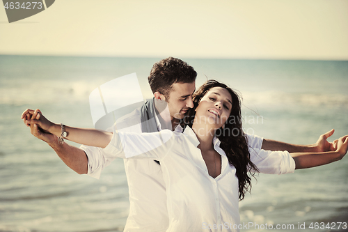 Image of happy young couple have fun at beautiful beach