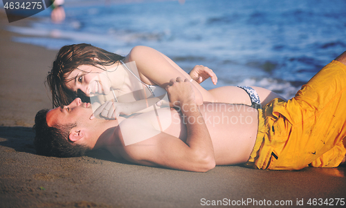 Image of happy young couple have romantic time on beach