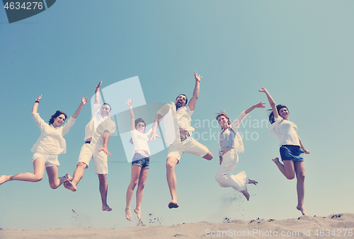 Image of happy people group have fun and running on beach