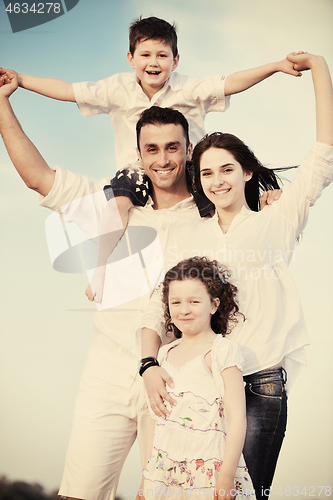 Image of happy young family have fun on beach