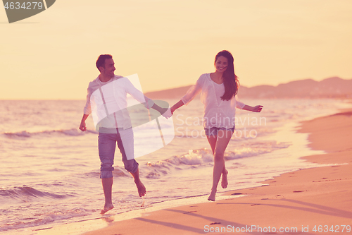 Image of young couple  on beach have fun