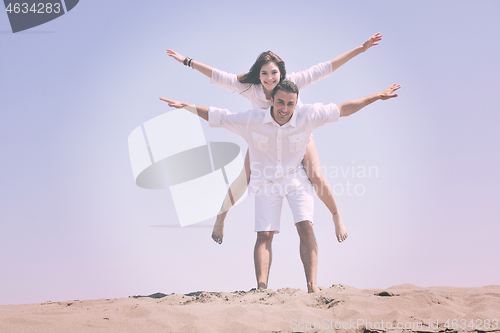 Image of happy young couple have fun on beach