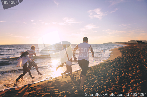 Image of people group running on the beach