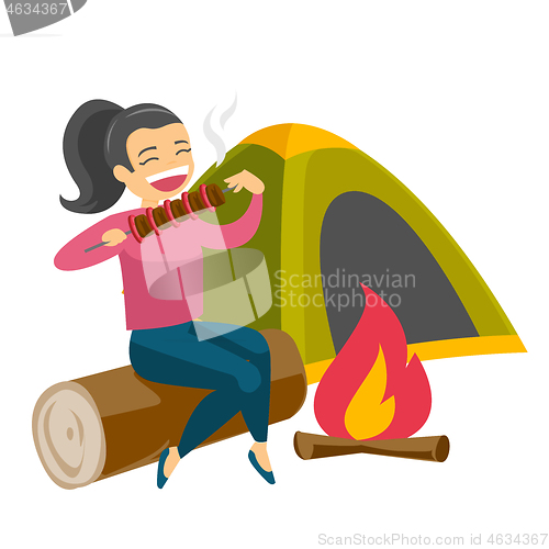 Image of Woman sitting on log near campfire in the camping.