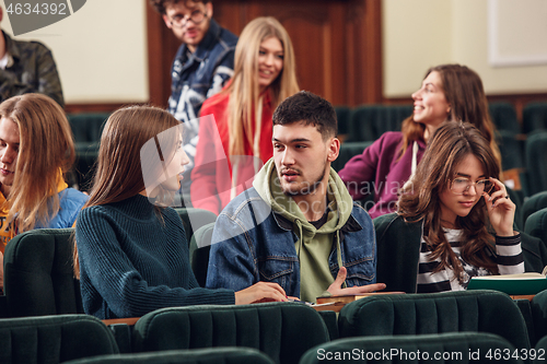 Image of The group of cheerful happy students sitting in a lecture hall before lesson