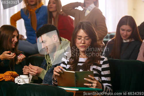 Image of The group of cheerful happy students sitting in a lecture hall before lesson