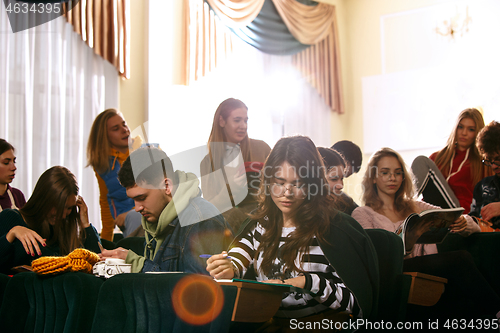 Image of The group of cheerful happy students sitting in a lecture hall before lesson