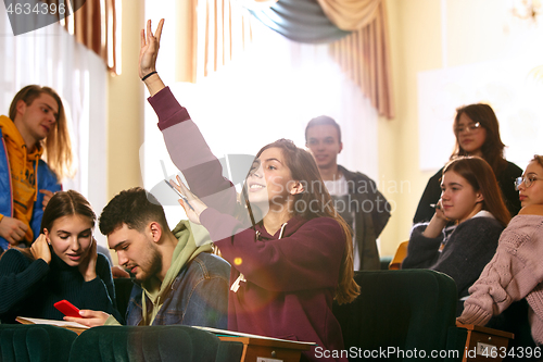 Image of The group of cheerful happy students sitting in a lecture hall before lesson