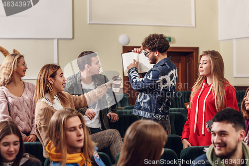 Image of The group of cheerful happy students sitting in a lecture hall before lesson