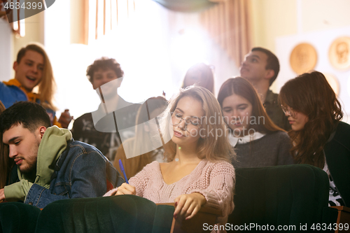 Image of The group of cheerful happy students sitting in a lecture hall before lesson