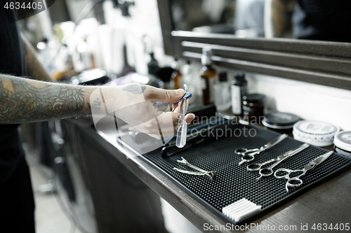 Image of Tools for cutting beard barbershop top view. Vintage tools of barber shop on wooden background