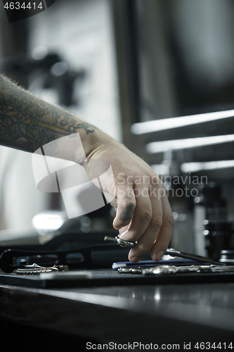 Image of Tools for cutting beard barbershop top view. Vintage tools of barber shop on wooden background