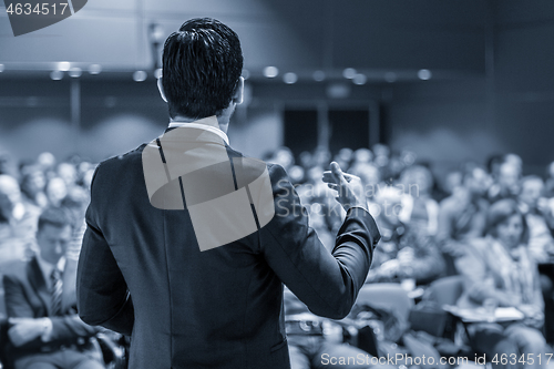 Image of Speaker giving a talk at business conference meeting.