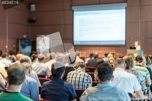 Image of Woman giving presentation in lecture hall at university.