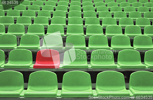 Image of Empty seats in a stadium with one special