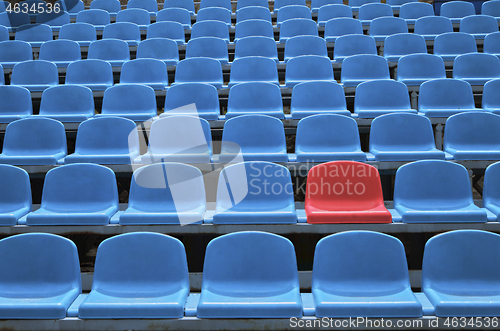 Image of Empty seats in a stadium with one special