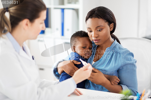 Image of mother with sick baby son and doctor at clinic