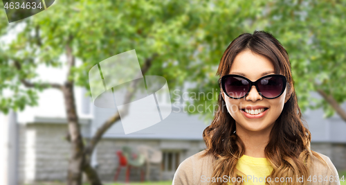 Image of happy smiling young asian woman in sunglasses