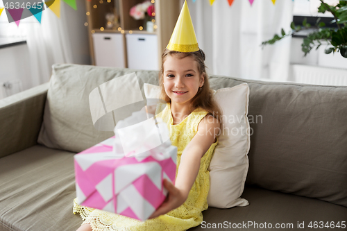 Image of happy girl with gift box on birthday at home