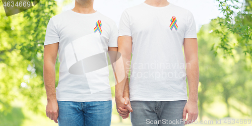 Image of close up of couple with gay pride rainbow ribbons