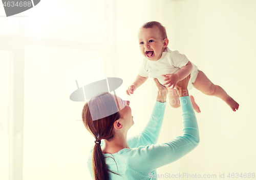 Image of happy young mother with little baby at home