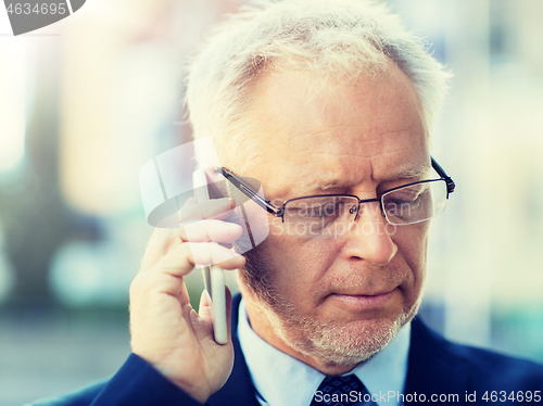 Image of close up of old businessman calling on smartphone