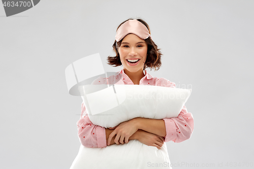 Image of woman with pillow in pajama and eye sleeping mask