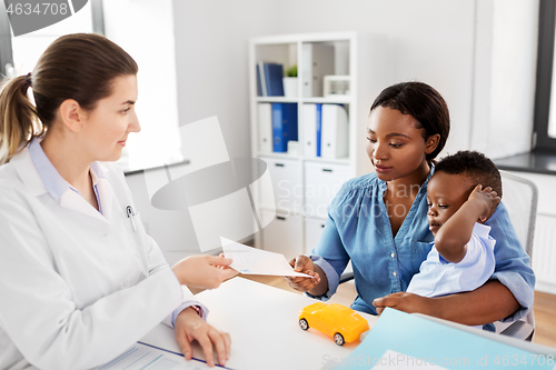 Image of mother with baby son and doctor at clinic