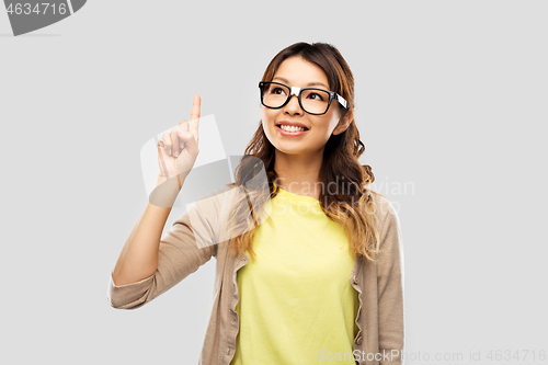 Image of asian woman in glasses or student with finger up