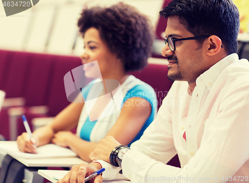 Image of international students with notebooks on lecture