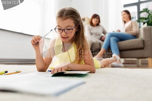 Image of student girl writing to notebook at home