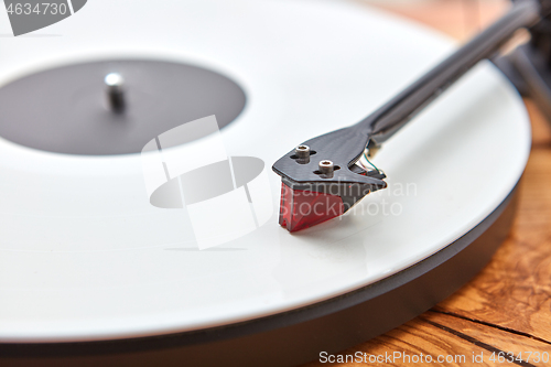 Image of Old-fashioned turnable record player on a wooden background.