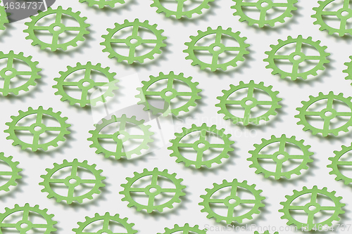 Image of Pattern from floating paper clockworks on a white background with shadows.