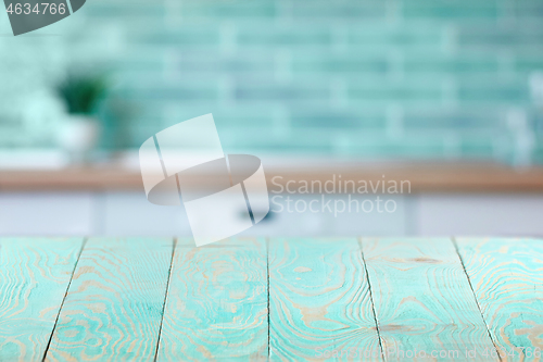 Image of Wooden textured blue table on a background of blurred interior.