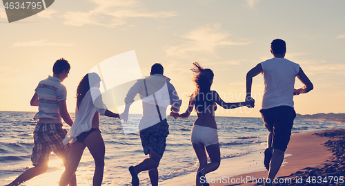 Image of people group running on the beach