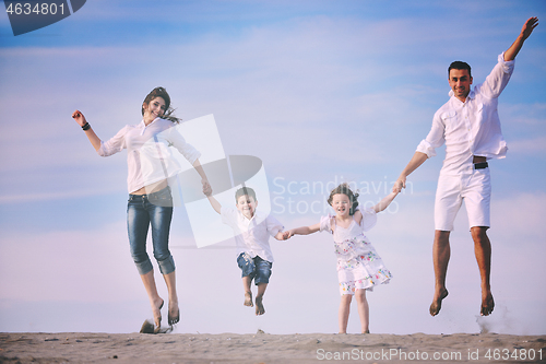 Image of family on beach showing home sign