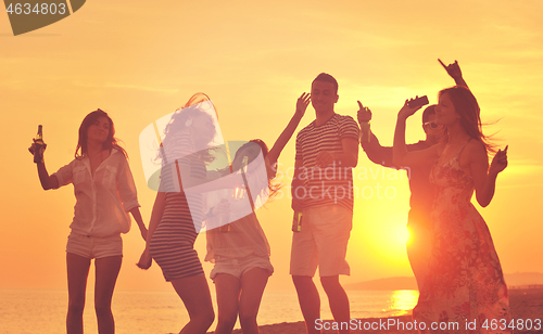 Image of Group of young people enjoy summer  party at the beach