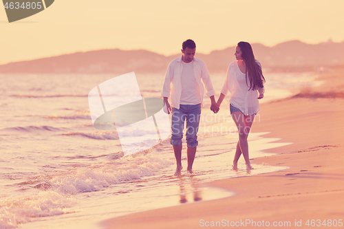 Image of young couple  on beach have fun